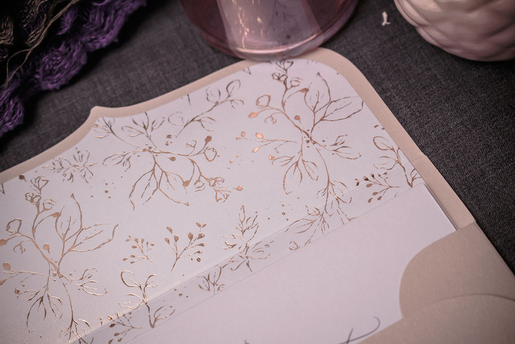rosegold béléses esküvői meghívó virágos díszítőmotívummal, gyöngyházfényű papíron, ezüst és púder színű borítékokkal