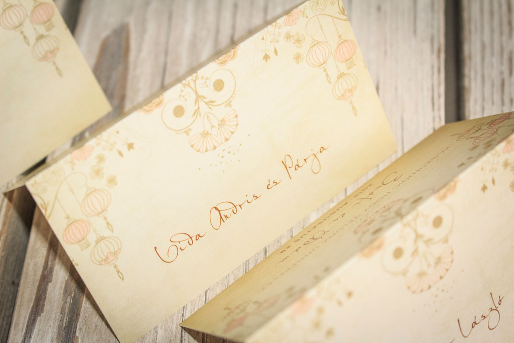 hajtott ültetőkártya rusztikus-lampionos grafikával – bármilyen esküvői dekorációhoz választható papírokon akár aranyozva is, gyors átfutással, kedvező áron